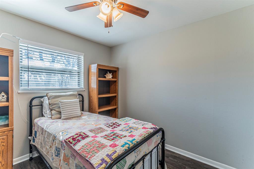 708 North Stewart Street Azle, TX 76020 - Photo 18 of 25 a bedroom with a bed and a window