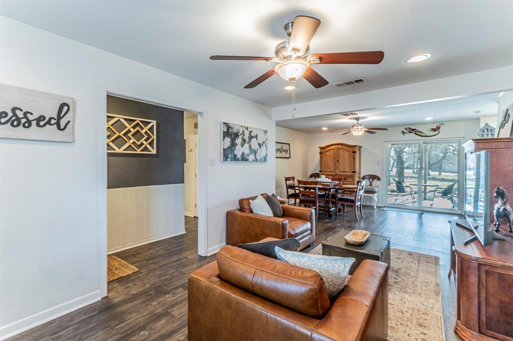 708 North Stewart Street Azle, TX 76020 - Photo 3 of 25 a living room with furniture kitchen view and a wooden floor
