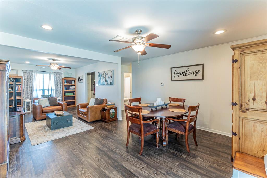 708 North Stewart Street Azle, TX 76020 - Photo 10 of 25 a view of a dining room with furniture wooden floor and chandelier
