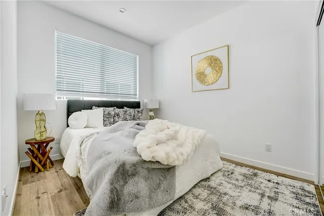 a bedroom with a bed and painting on the wall