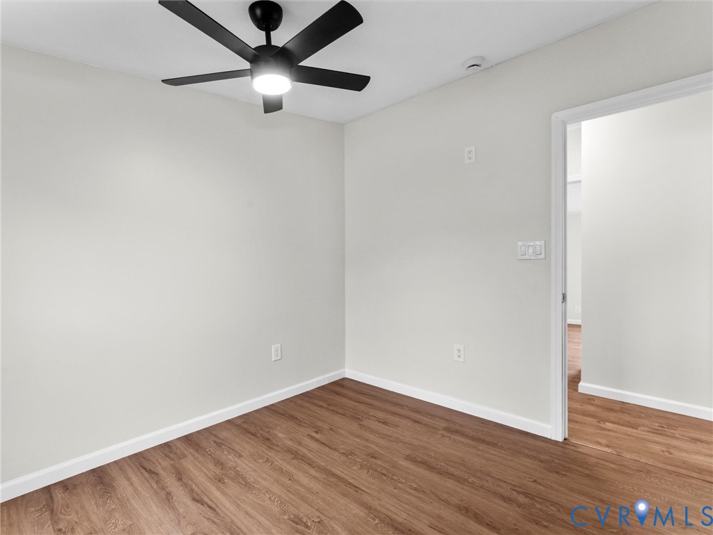 4772 Carsley Road Waverly, VA 23890 - Photo 23 of 38 Empty room with wood finished floors and ceiling f