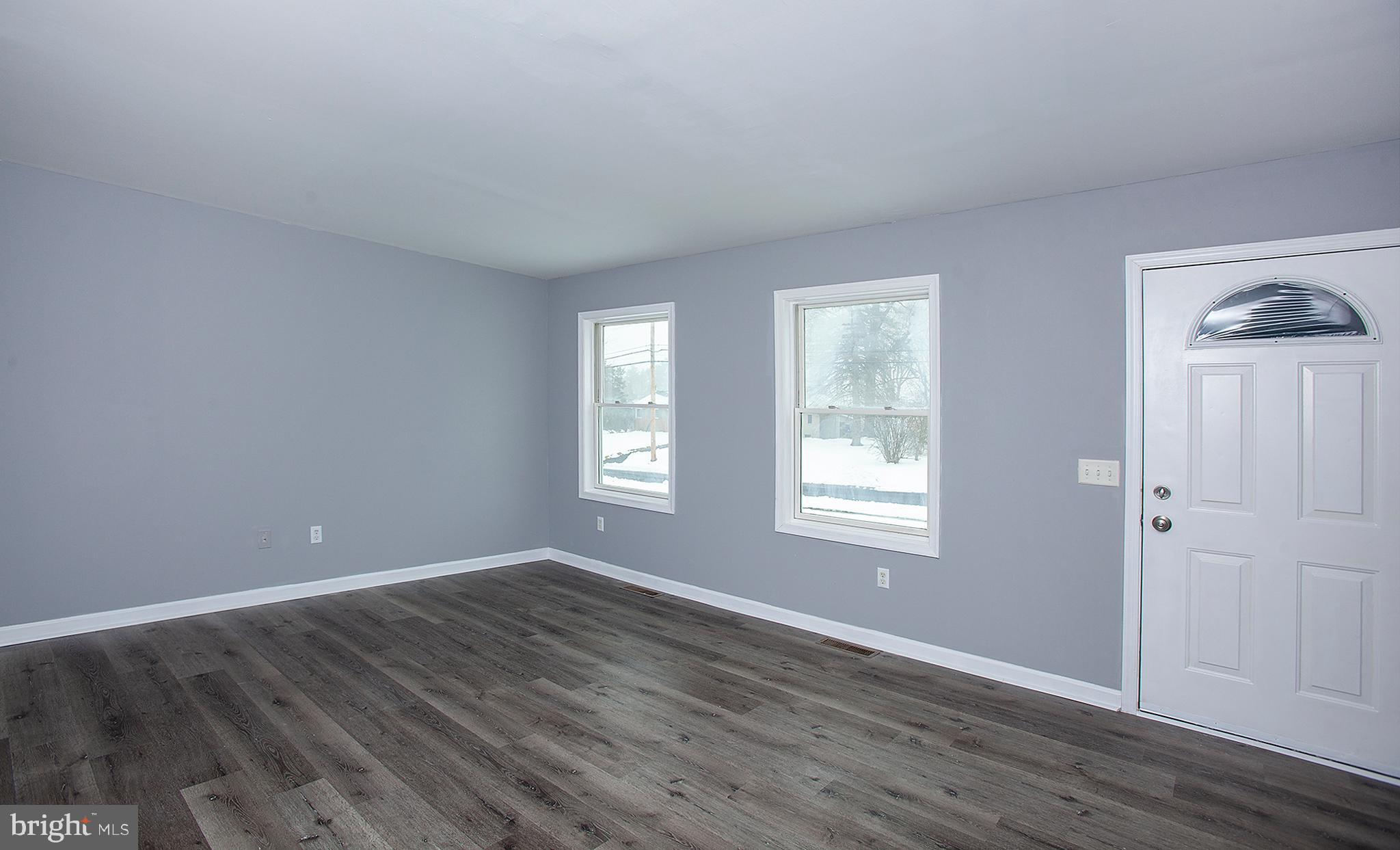1031 Oberlin Road Middletown, PA 17057 - Photo 16 of 39 a view of an empty room with wooden floor and a window