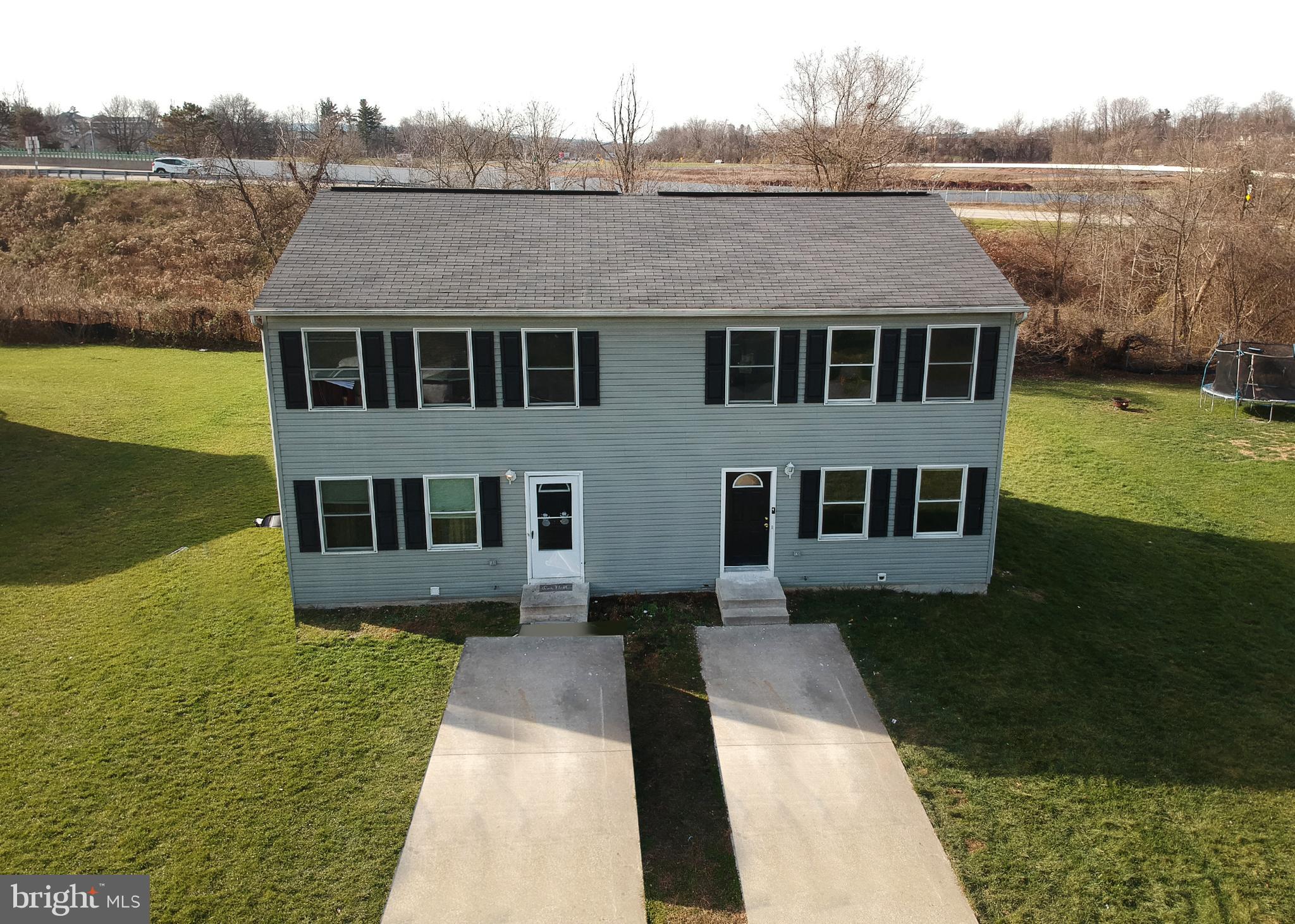 1031 Oberlin Road Middletown, PA 17057 - Photo 2 of 39 a aerial view of a house next to a lake with a big yard