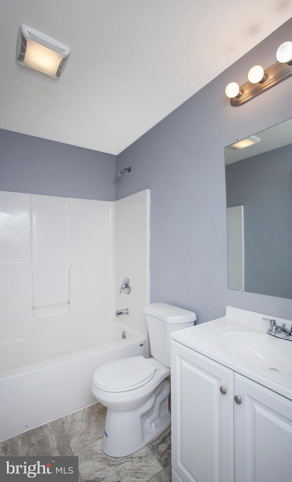 1031 Oberlin Road Middletown, PA 17057 - Photo 32 of 39 a bathroom with a toilet a sink a vanity and mirror