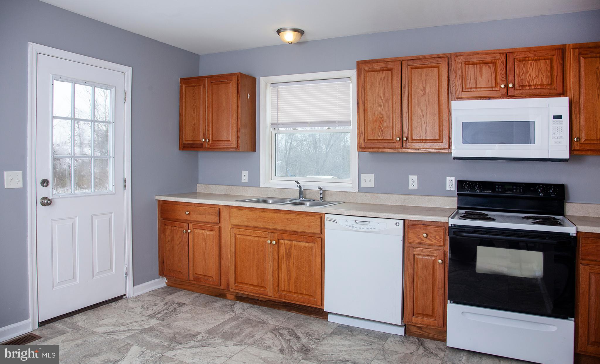 1031 Oberlin Road Middletown, PA 17057 - Photo 7 of 39 a kitchen with granite countertop cabinets stainless steel appliances a sink and a window