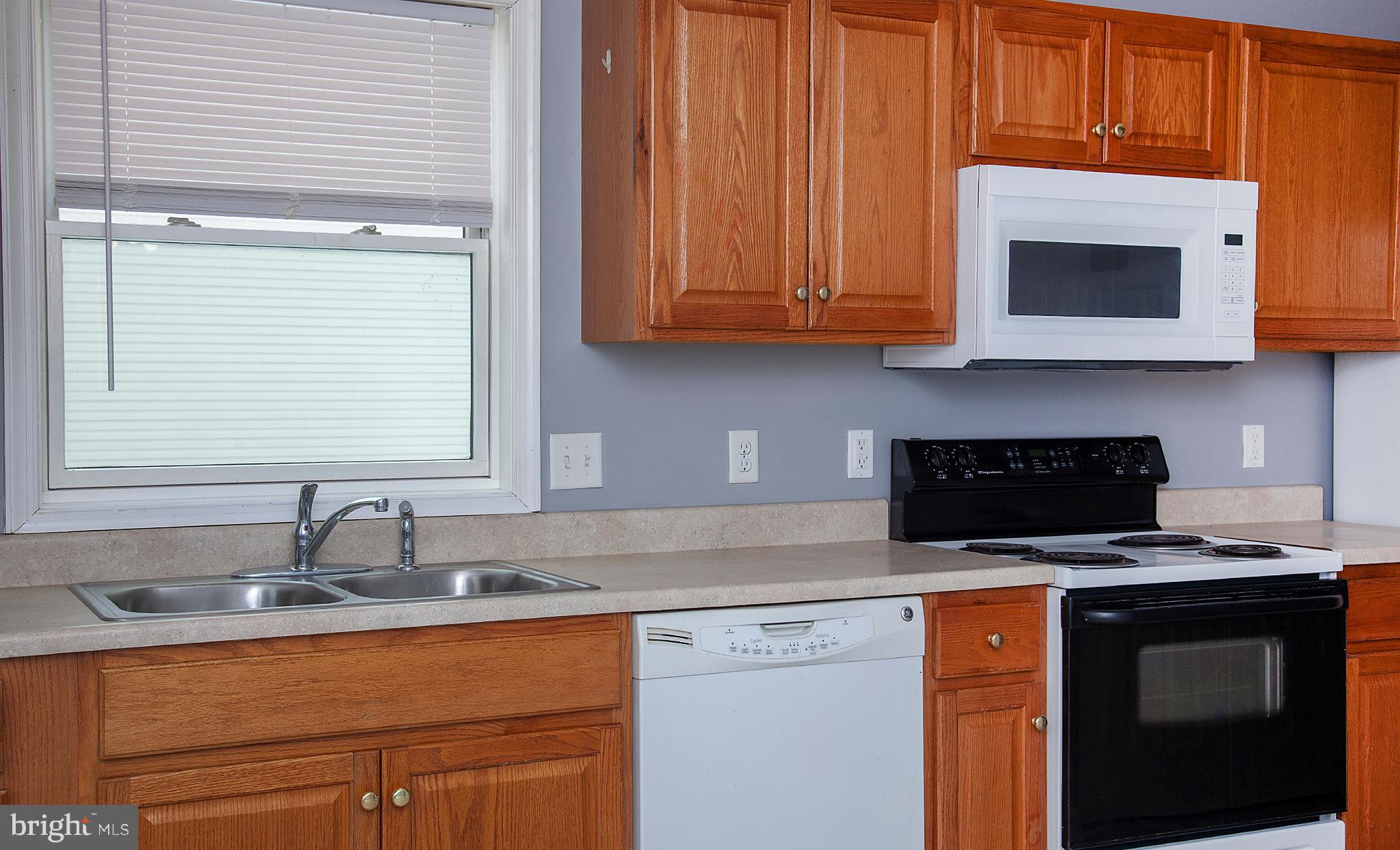 1031 Oberlin Road Middletown, PA 17057 - Photo 9 of 39 a kitchen with stainless steel appliances granite countertop a sink stove and microwave