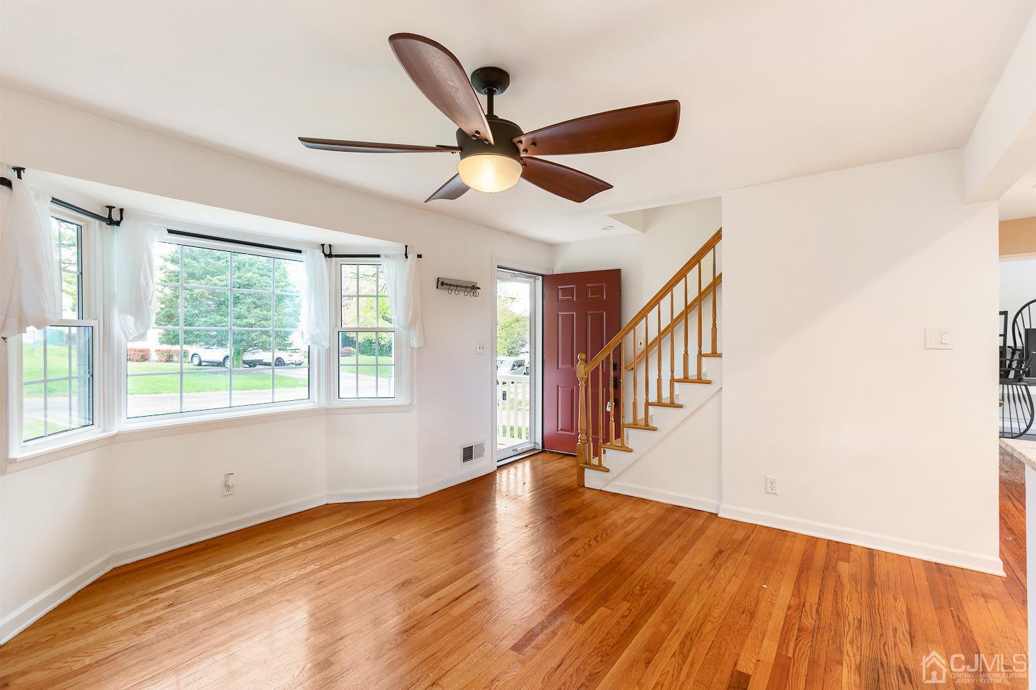 60 Wilcox Road New Brunswick, NJ 08901 - Photo 5 of 25 a view of an empty room with wooden floor and a window