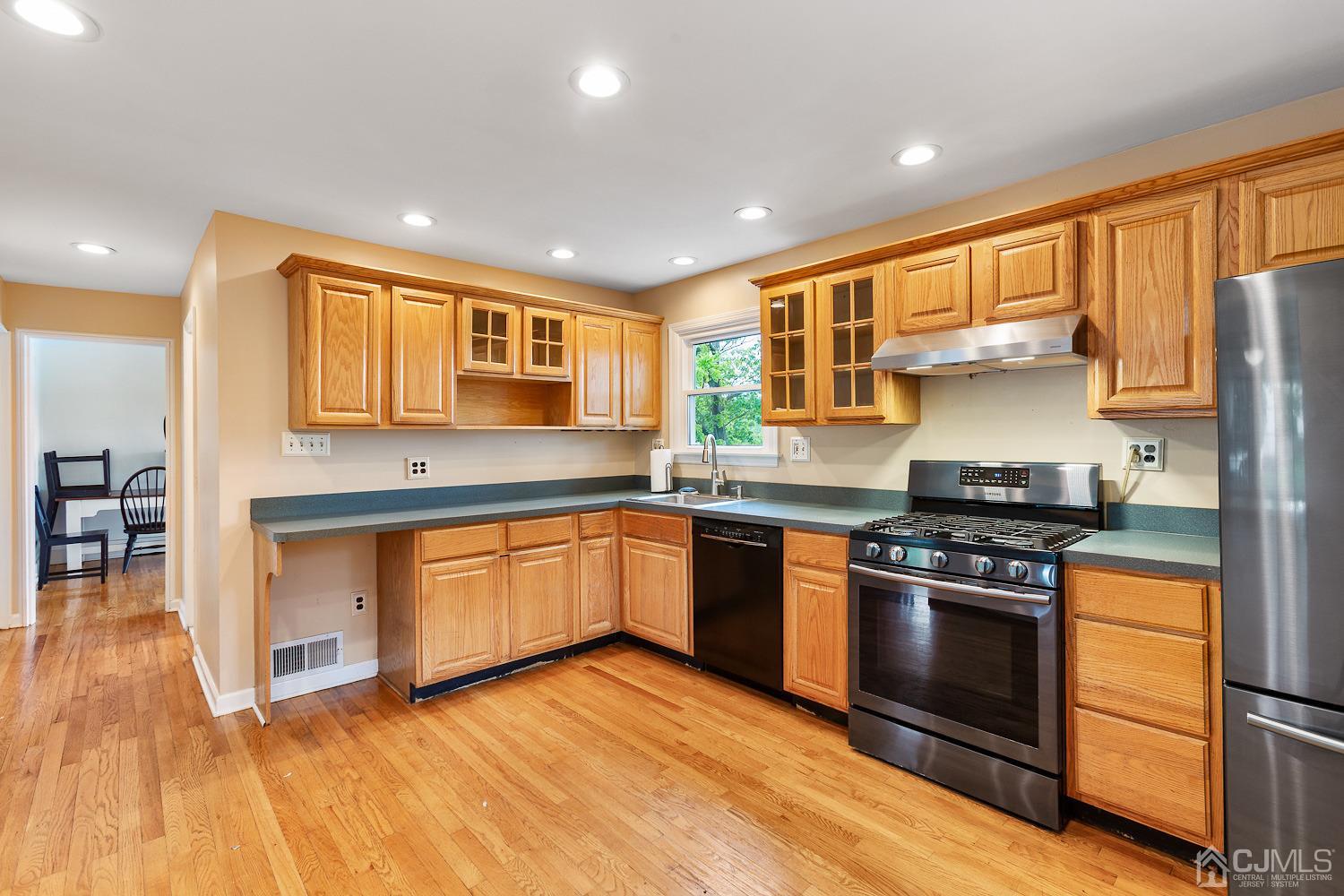 60 Wilcox Road New Brunswick, NJ 08901 - Photo 8 of 25 a kitchen with stainless steel appliances granite countertop a stove and a sink