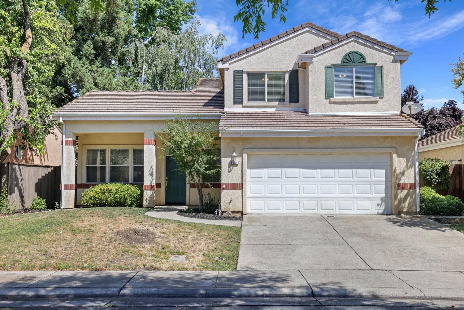 3064 Carousel Circle Stockton, CA 95219 - Photo 1 of 1 a front view of a house with garden