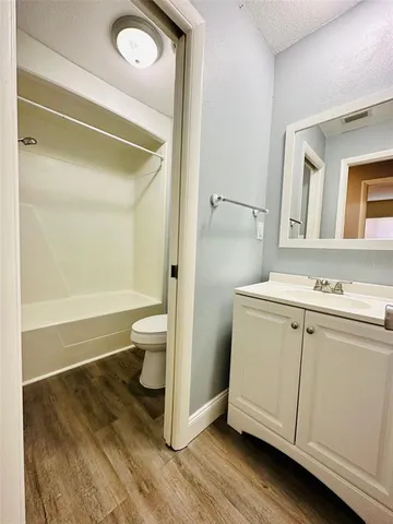 a bathroom with a sink a toilet and a shower