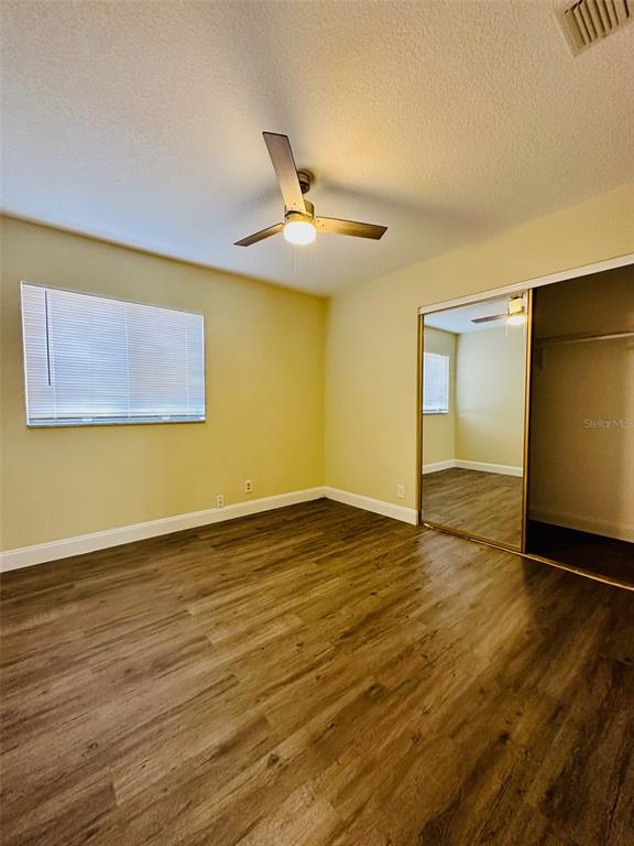 8002 Hibiscus Drive, Unit 8002 Temple Terrace, FL 33637 - Photo 15 of 16 a view of empty room with wooden floor