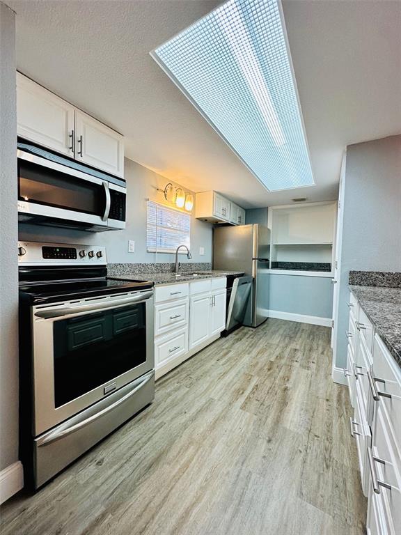 8002 Hibiscus Drive, Unit 8002 Temple Terrace, FL 33637 - Photo 9 of 16 a kitchen with stainless steel appliances and stove top oven