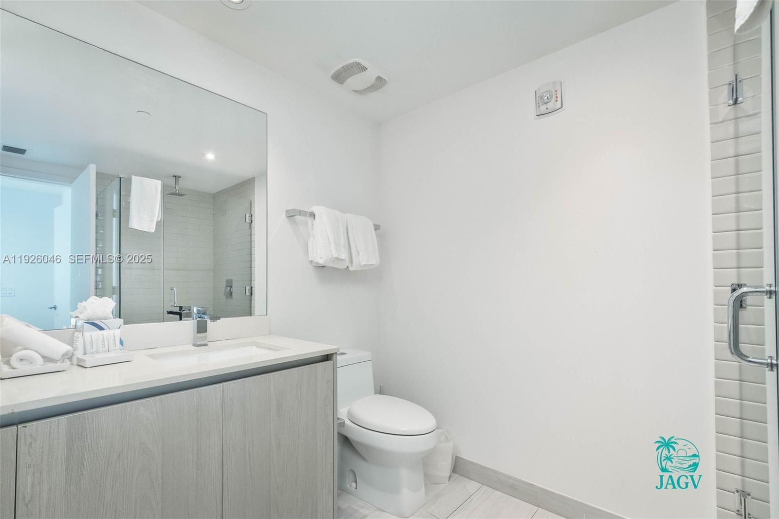 4010 South Ocean Drive, Unit R3005 Hollywood, FL 33019 - Photo 22 of 57 a bathroom with a sink toilet and a mirror