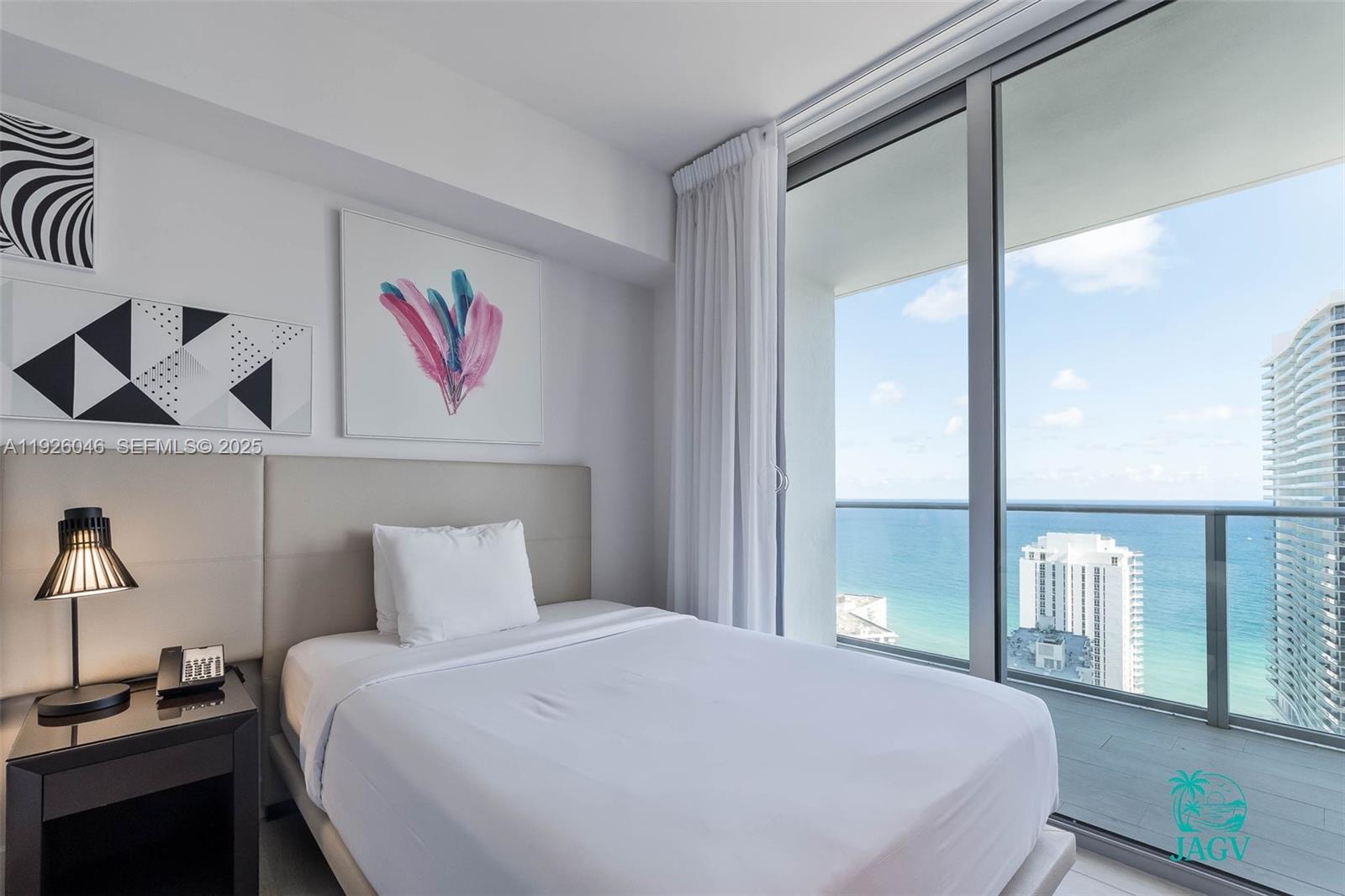 4010 South Ocean Drive, Unit R3005 Hollywood, FL 33019 - Photo 25 of 57 a bedroom with a bed and a large window