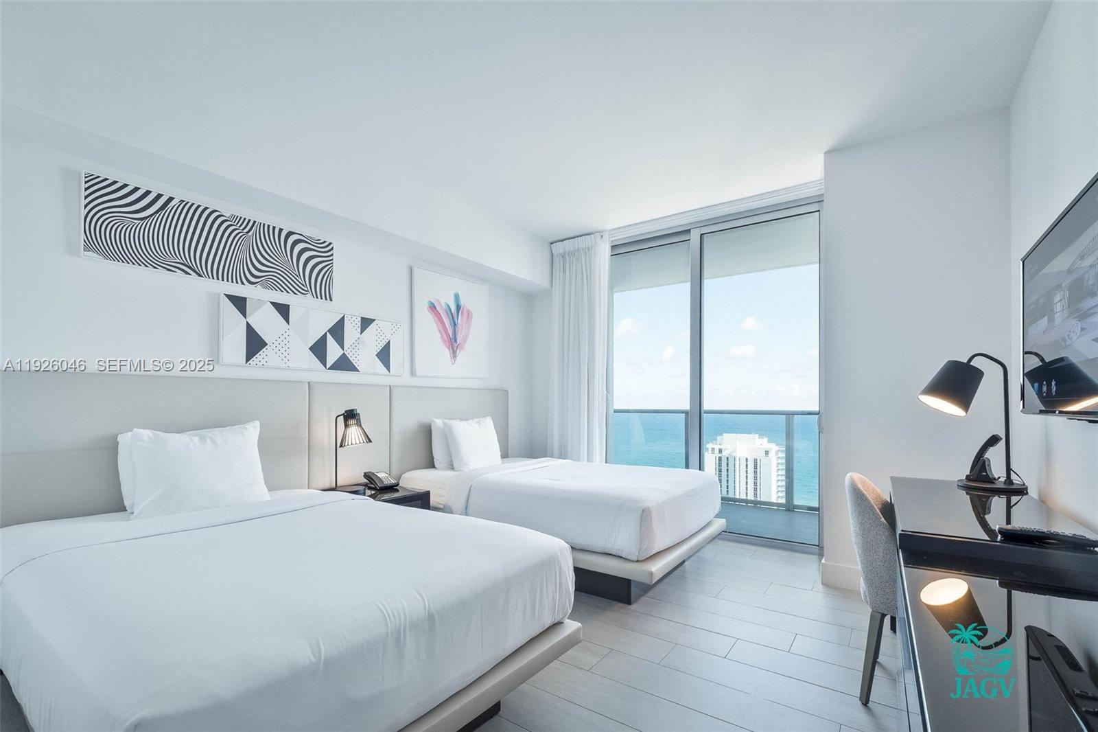 4010 South Ocean Drive, Unit R3005 Hollywood, FL 33019 - Photo 27 of 57 a bedroom with two beds and a window