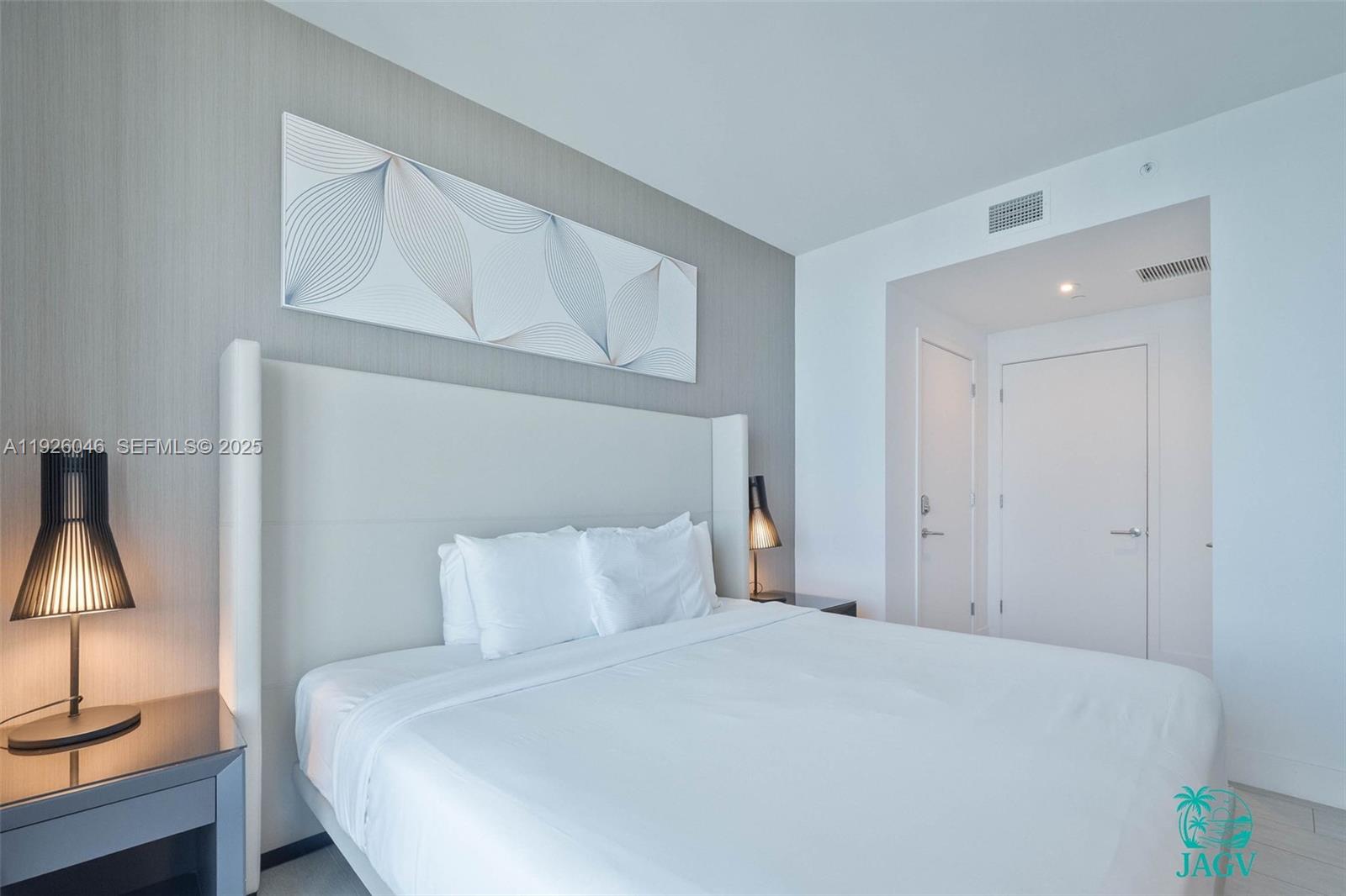 4010 South Ocean Drive, Unit R3005 Hollywood, FL 33019 - Photo 35 of 57 a bedroom with a bed and a lamp