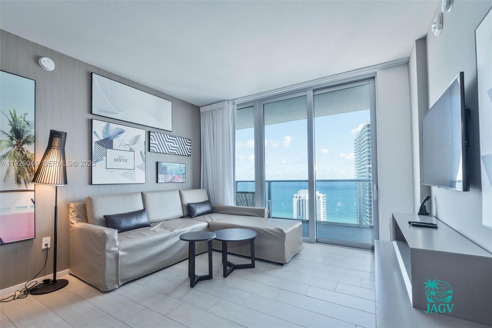 4010 South Ocean Drive, Unit R3005 Hollywood, FL 33019 - Photo 38 of 57 a living room with furniture and a large window