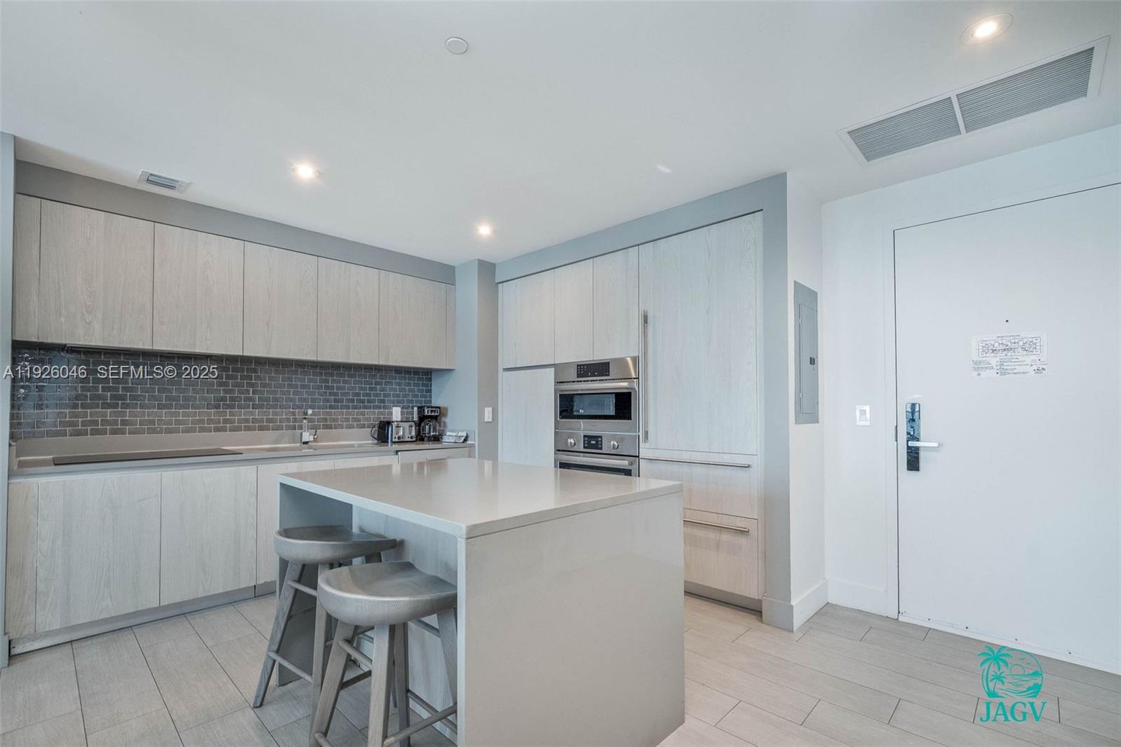 4010 South Ocean Drive, Unit R3005 Hollywood, FL 33019 - Photo 45 of 57 a kitchen with a sink a stove a refrigerator and white cabinets
