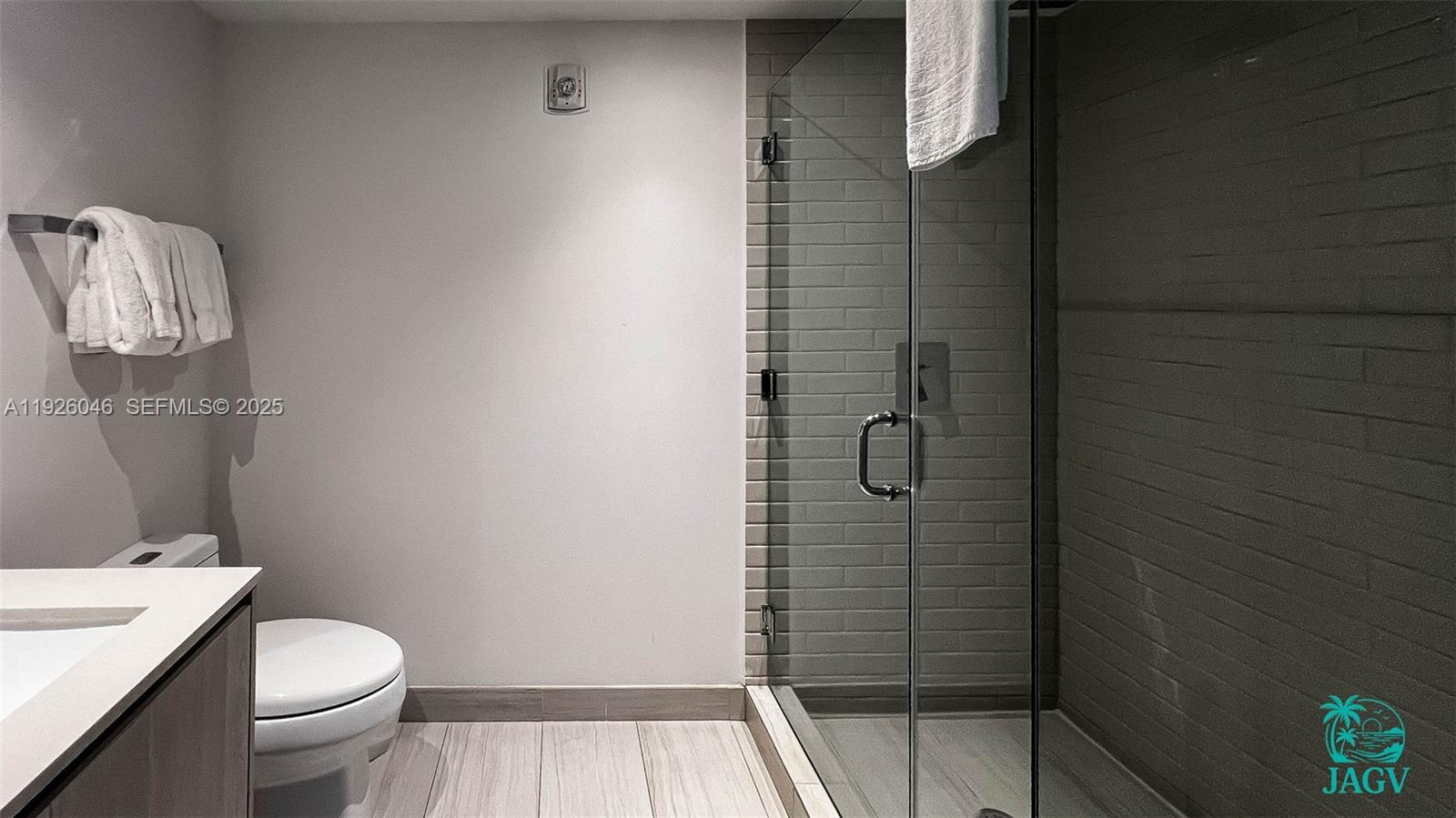 4010 South Ocean Drive, Unit R3005 Hollywood, FL 33019 - Photo 51 of 57 a bathroom with a granite countertop toilet and a shower