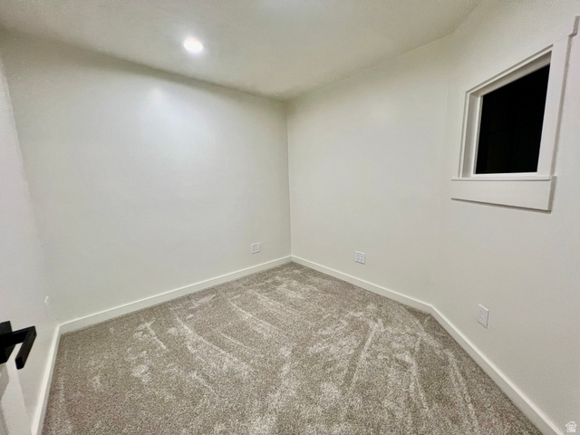 812 East Bates Cyn Road Tooele, UT 84074 - Photo 75 of 144 Room featuring neutral wall finishes, light-toned carpeting, a recessed ceiling light, and a single window with white trim
