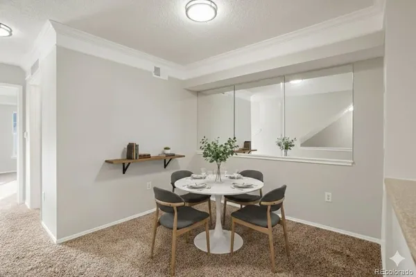 a view of a dining room with furniture and window