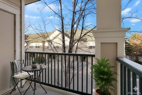 a view of a two chairs in the balcony