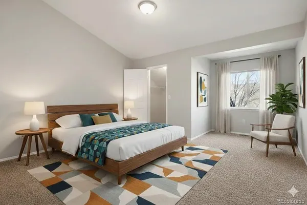 a bedroom with a bed and a chair