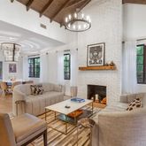 a living room with furniture fireplace and chandelier