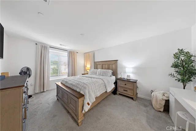 a spacious bedroom with a bed and a table