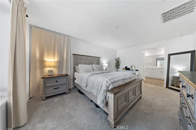 a bedroom with a bed and a tv on the dresser