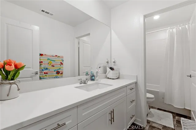 a bathroom with a sink a vanity and a mirror