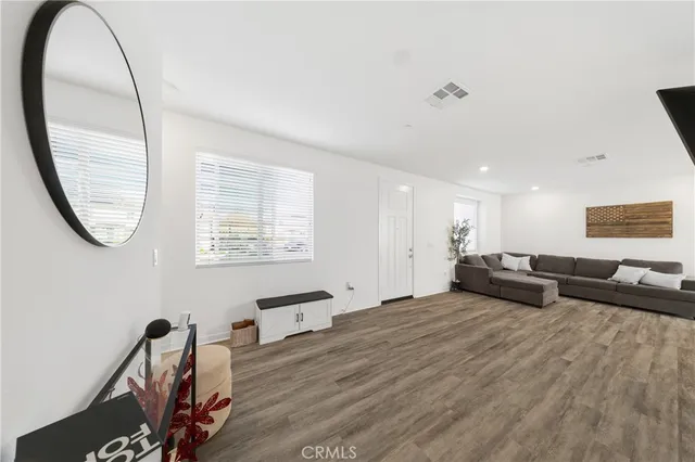 a living room with furniture and a mirror