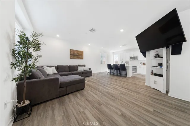 a living room with furniture flat screen tv and a fireplace