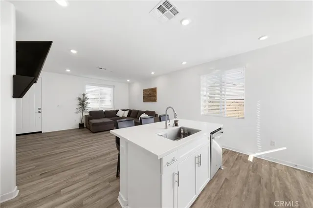 a kitchen with sink attached with living room