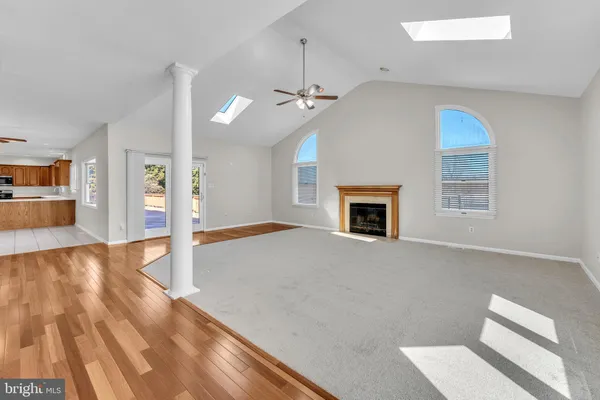 a kitchen with stainless steel appliances granite countertop a sink and dishwasher a stove top oven with wooden floor