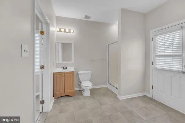 a view of staircase with white walls and a window
