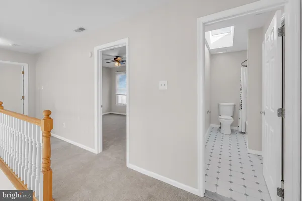 a view of staircase with white walls and white door