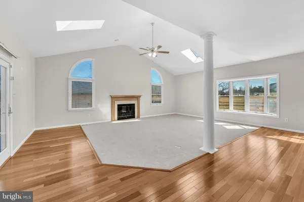 wooden floor in an empty room with a fireplace