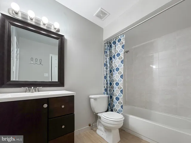 a bathroom with a sink toilet a mirror and shower