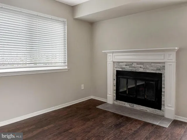 a living room with a fireplace and a fireplace