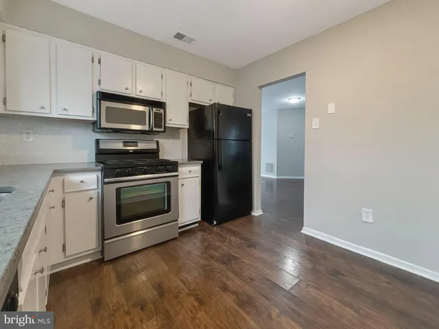 a kitchen with a stove a microwave and a refrigerator