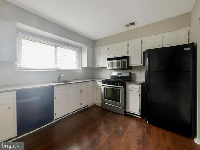 a kitchen with a refrigerator stove and microwave