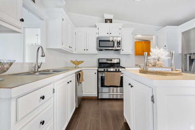 2600 North Hill Field Road, Unit 86 Layton, UT 84041 - Photo 7 of 25 Kitchen featuring stainless steel appliances, light countertops, white cabinetry, and crown molding