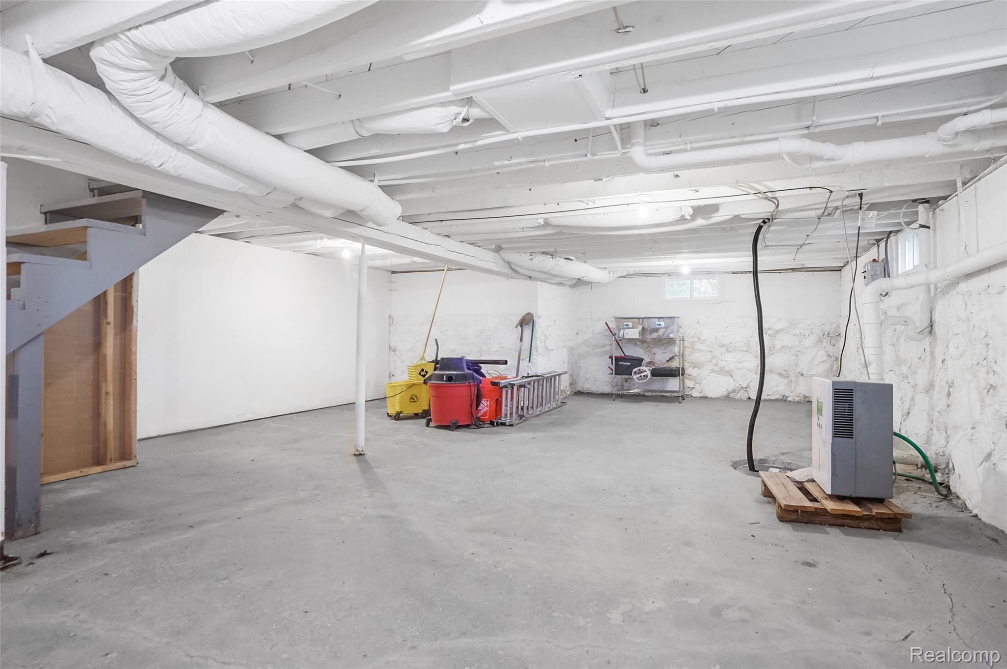 8330 Baldwin Road Gaines, MI 48436 - Photo 22 of 27 Lower level featuring painted foundation walls, exposed overhead beams, and a concrete floor
