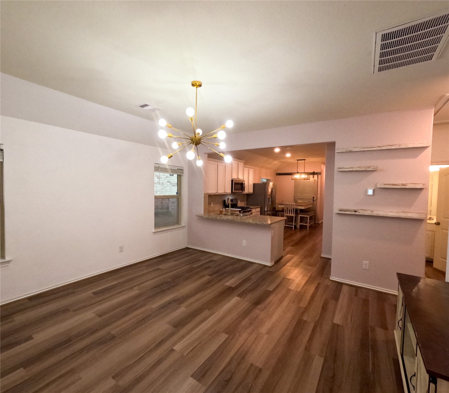 5515 Savanna Pasture Road Katy, TX 77493 - Photo 3 of 17 a view of a kitchen with a sink and wooden floor