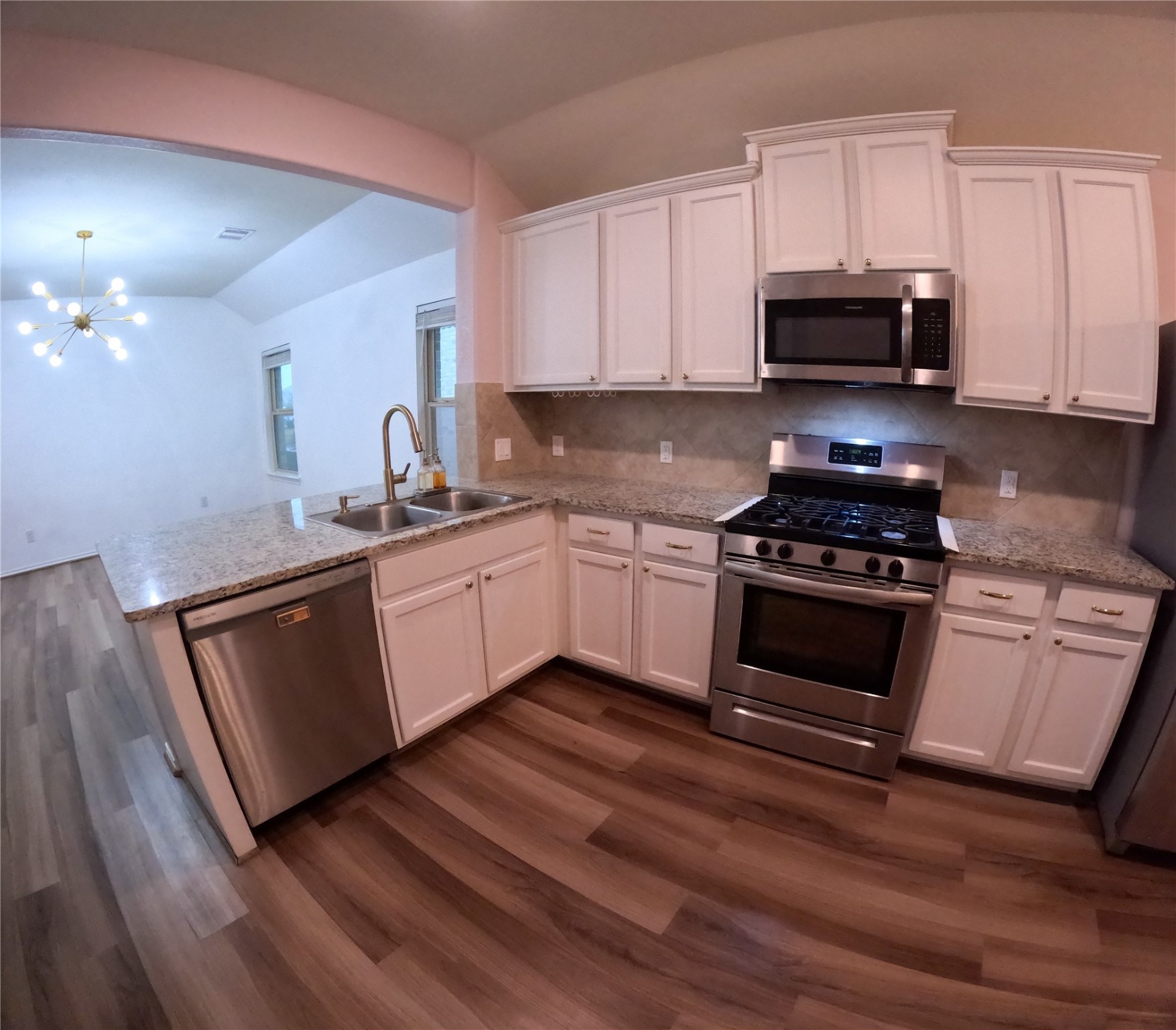 5515 Savanna Pasture Road Katy, TX 77493 - Photo 5 of 17 a kitchen with granite countertop a sink cabinets and stainless steel appliances