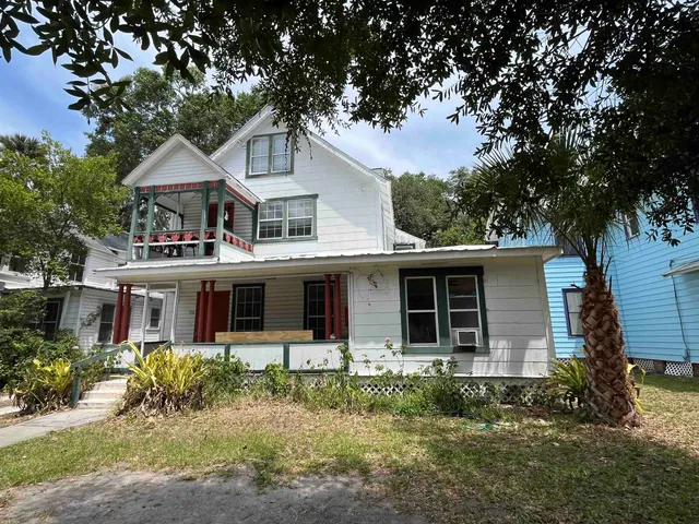 a house that has tree in front of it