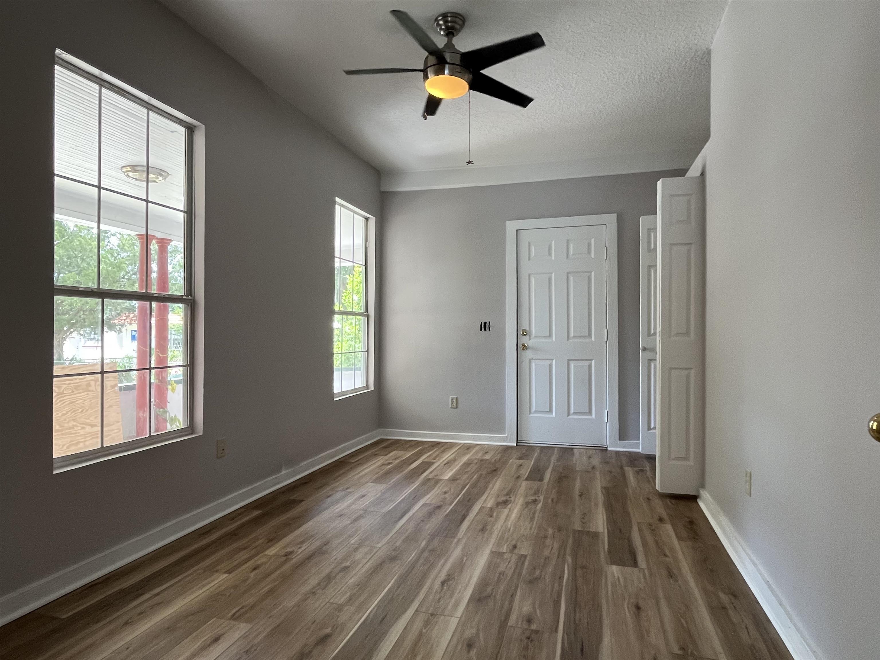 116 Bridge Street, Unit 1 St. Augustine, FL 32084 - Photo 3 of 8 a view of empty room with wooden floor and fan