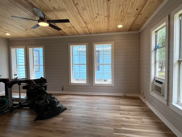 a room with window wooden floor and furniture
