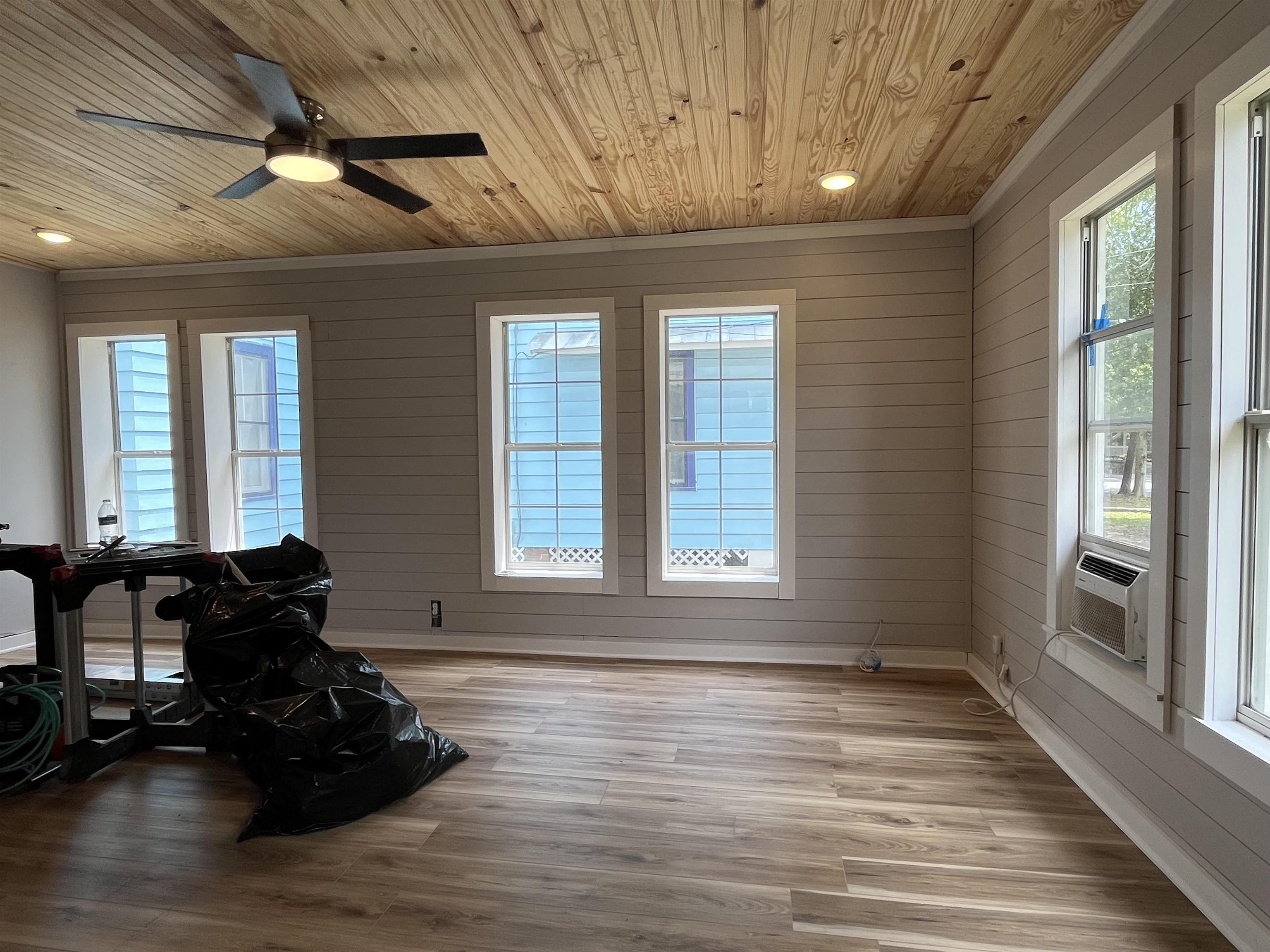 116 Bridge Street, Unit 1 St. Augustine, FL 32084 - Photo 4 of 8 a room with window wooden floor and furniture